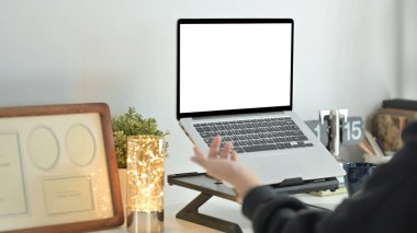 Cropped image of creative woman freelancer having video call via laptop at modern home office.