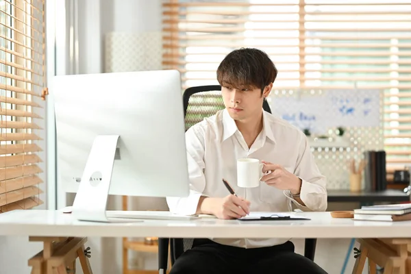 Attractive Young Businessman White Shirt Looking Computer Monitor Making Notes — Stock Fotó