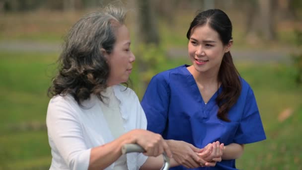 Pleasant Caregiver Supporting Talking Elderly Woman Outdoor Rehab Center Nursing — Stock Video