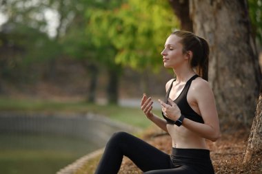 Spor salonundaki kadın dışarıda antrenman yaptıktan sonra dinleniyor. Fitness, spor ve sağlıklı yaşam tarzı kavramı.