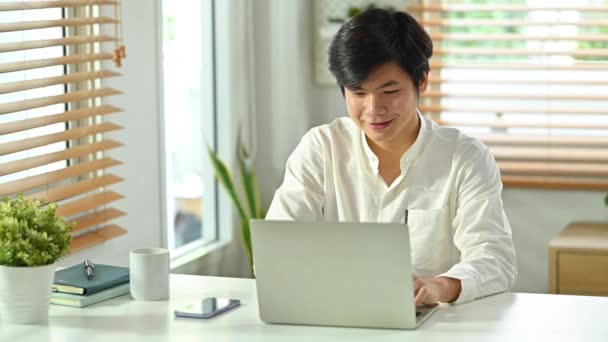 Smiling Handsome Asian Man Answering Email Working Online Laptop Computer — Stock Video