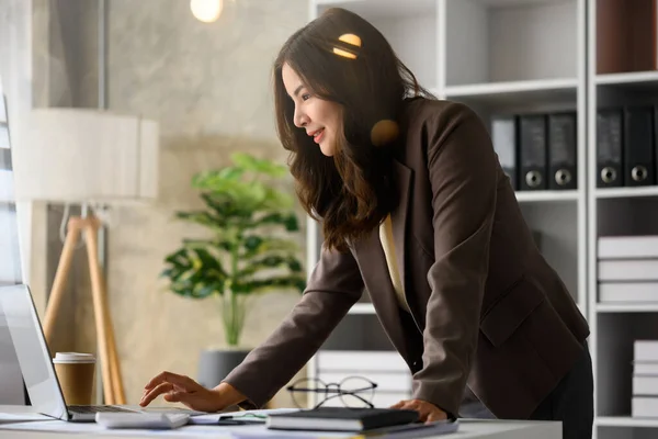 職場に立つスマート女性会計士とラップトップコンピュータ上のオンライン情報をチェック — ストック写真
