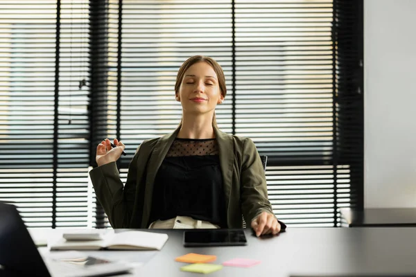 Stock image Millennial caucasian businesswoman leaning back in comfortable office chair with closed eyes, resting from computer work.