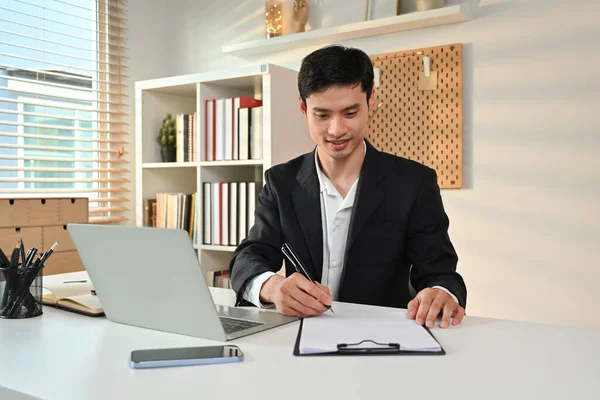 Stock image Image of professional businessman in formalwear writing his strategy, signing a contract at working desk.