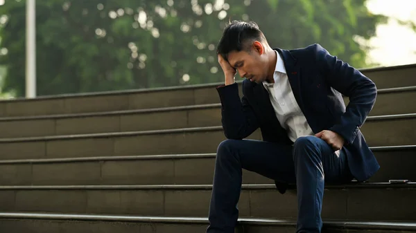 stock image Image of upset man employee sitting on stairs outside office building, financial crisis, unemployed concept.