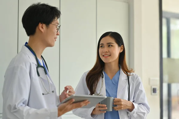 Two Professional Doctors Discuss Patient Diagnosis Data Digital Tablet Standing — Stock Photo, Image