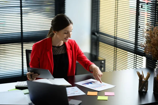 stock image Attractive caucasian woman entrepreneur in red suit working on new business strategy at contemporary office.