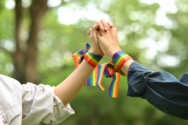 虹色の意識のリストバンドを手を保持を身に着けている同性愛カップルのクロップショット Lgbtqコミュニティのコンセプト — ストック写真