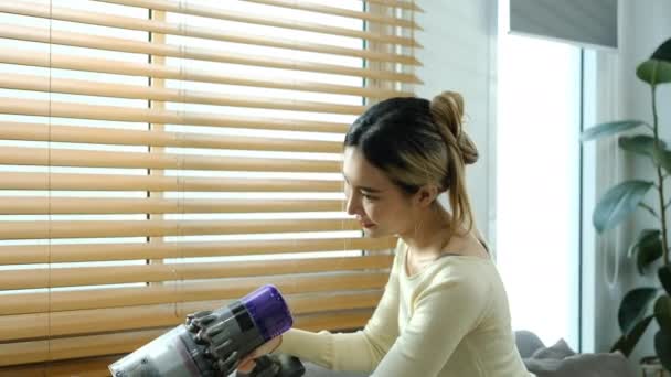 Millennial Asian Woman Vacuuming Sofa Cordless Handheld Vacuum Cleaner Housework — Stock Video
