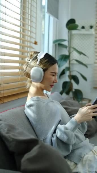 Vertikální Záběr Radostné Mladé Ženy Sluchátkách Hraní Videohry Digitálním Tabletu — Stock video