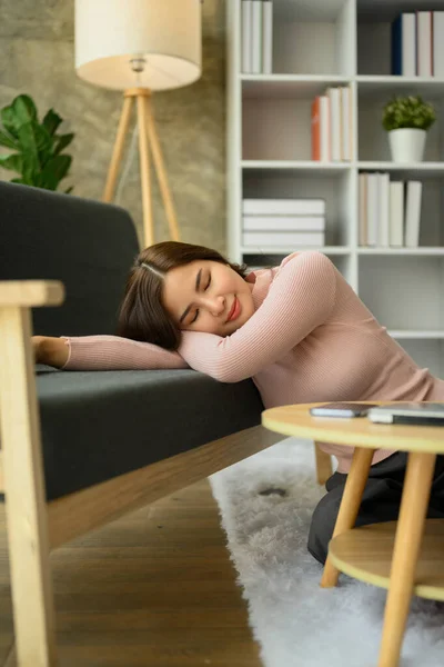 stock image Serene young asian woman leaning on sofa, taking a break during remote work day at home.