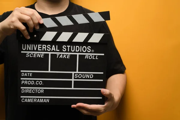 Man Holding Black Clapperboard Yellow Background Video Production Film Cinema — Stock Photo, Image