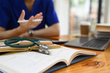 Tıp öğrencisi mavi önlük giyiyor dijital tablet kullanıyor, üniversite sınavlarına hazırlanıyor. Tıbbi staj konsepti. 