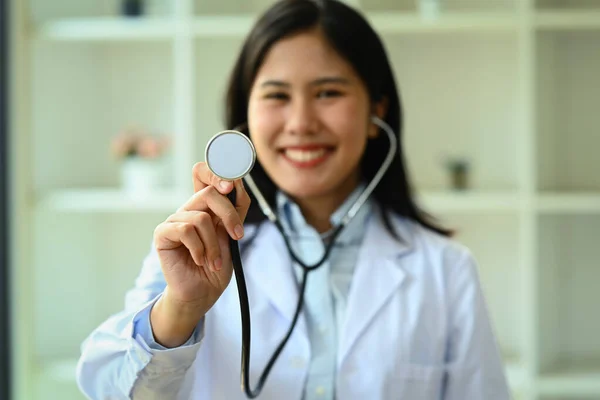 Confident Female Doctor Dressed White Uniform Holding Stethoscope Smiling Camera — Stock Photo, Image