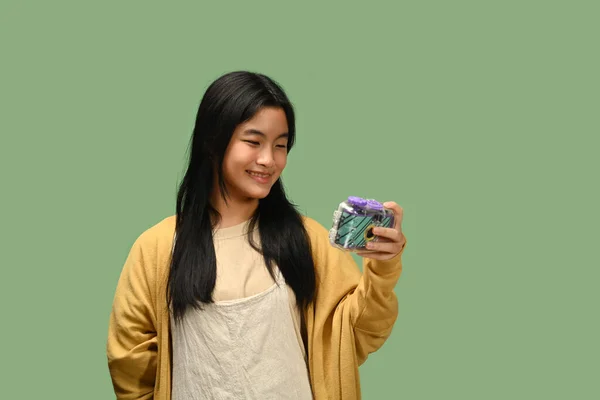 Kameralı Gülümseyen Asyalı Genç Kız Yeşil Arka Planda Yalnız Poz — Stok fotoğraf
