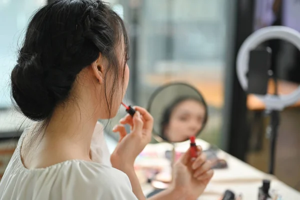 Genç Bir Kadın Aynanın Önünde Dudaklarına Ruj Sürüyor Akıllı Telefonuyla — Stok fotoğraf