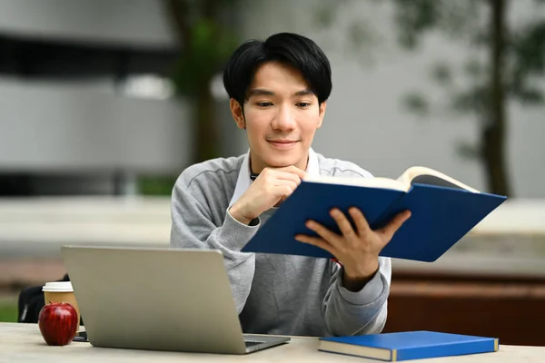 Smiling Man Reading Book Studying Exam Doing Homework Remotely Table — Stock Photo, Image