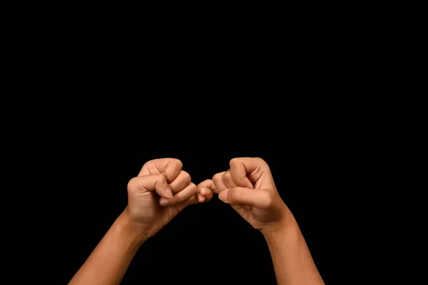 黒い背景 約束や恩赦のシンボルで互いに小さな指をホックする2つの手 — ストック写真