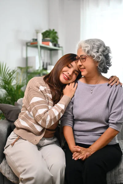 stock image Smiling Asian woman embracing mature mother expressing unconditional love.