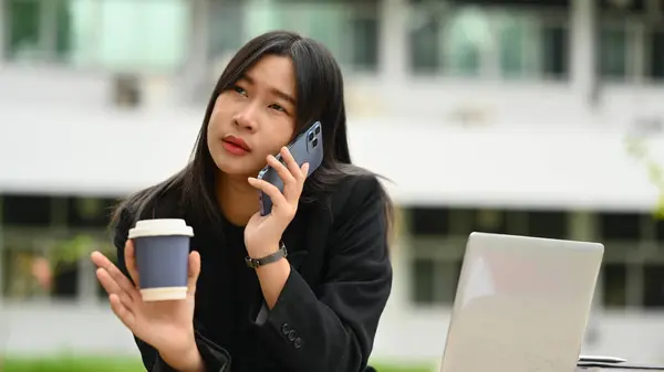 亚洲自由撰稿人在户外用手机聊天的照片 — 图库照片