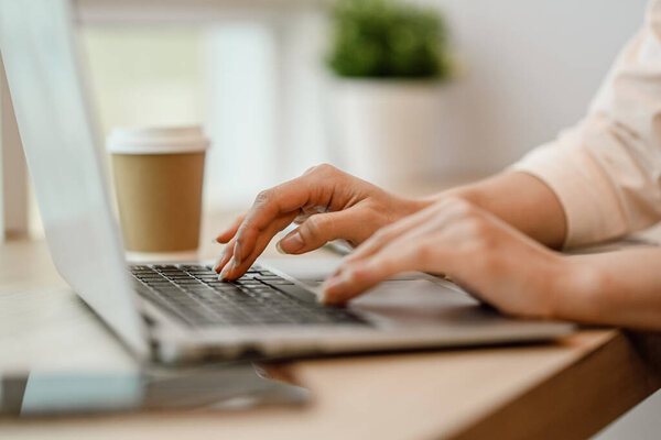 Closeup businesswoman hands typing on laptop searching information or working online