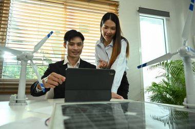 Ofiste sürdürülebilir yenilik projesi üzerinde çalışan iki meslektaş. Yeşil enerji geliştirme kavramı.