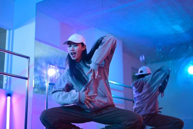 Stüdyoda modern hip hop dansı yapan genç bir kadın. Hobiler ve aktif yaşam tarzı.