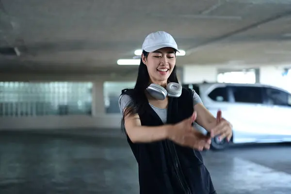 Talented young woman dancing Hip hop dance in parking garage. Hobby and active lifestyle concept.