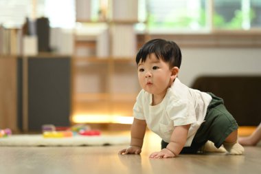 Sevimli küçük oğlan yerde sürünürken eğleniyor. Çocuk gelişimi kavramı.