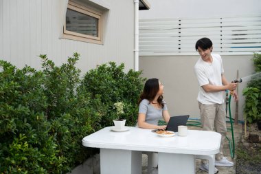 Mutlu Asyalı çift rahat arka bahçede birlikte vakit geçiriyor..