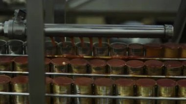 Otomatik dolum sistemi deniz ürünleri fabrikasındaki alüminyum kutulara sos döküyor.