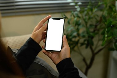 Beyaz ekranlı akıllı telefonu tutan kadının yakın görüntüsü.