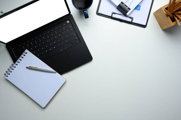 Top view of modern workspace with laptop and notebook..