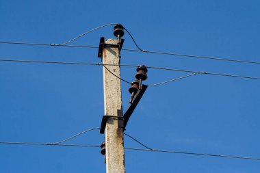 A fragment of a concrete pole with a power line