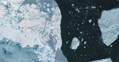 Top down icebergs at ocean bay aerial. Environment climate change, global warming. Melting glacier in ice fjord in Antarctica. Arctic nobody nature landscape in Unesco World Heritage Site drone shot clipart