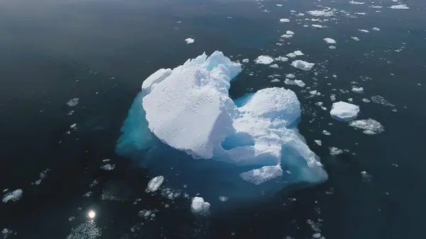 Close-up Iceberg Floating In Antarctica Ocean. Aerial Flight Over South Pole. Drone Overview Of Massive Glacier In Clear Ocean. Sun Reflection In Pure Water. Wild Polar Nature. 4k Footage.