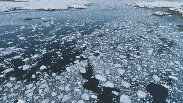 Zodiac Boat Float in Melting Brash Ice Aerial View. Drone Zoom In Flight Shot of Rubber Boat Sail in Antarctic Ocean Glacier. Winter Arctic Adventure Footage in 4K UHD