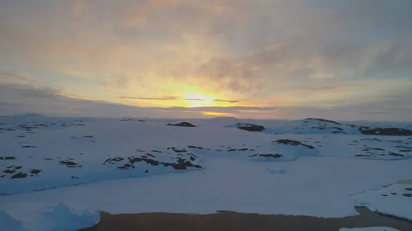 Arctic Sunrise Sky Over Mountain Aerial View. Antarctica Majestic Dynamic Sunset Horizon Landscape. Polar Sun Rise Above Beautiful Cloud in South Pole Nature Drone Footage Shot in 4K UHD