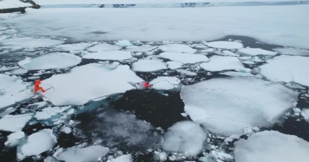 Два Человека Скафандрах Тают Арктический Лёд Люди Оранжевых Гидрокостюмах Пытаются — стоковое видео