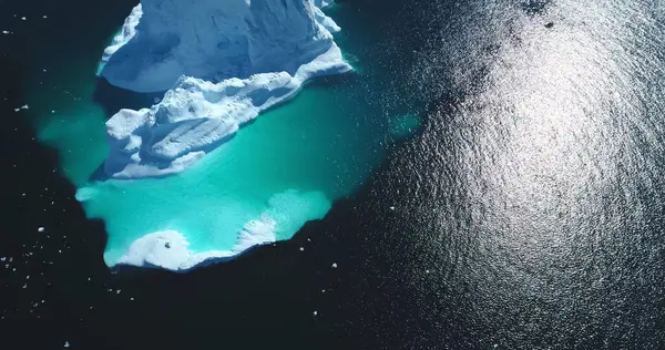 stock image Ecology, global warming in Antarctica. Melting ice, climate change background. Aerial top down giant iceberg floating blue ocean water. Winter polar landscape, arctic ice nature beauty. Drone panorama