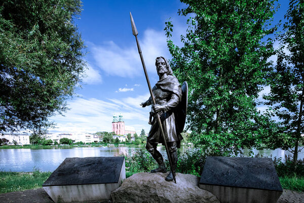 Gniezno, Poland - August 24, 2023: a monument to Lech, the legendary founder of Gniezno, pointing to the Royal Gniezno Cathedral.