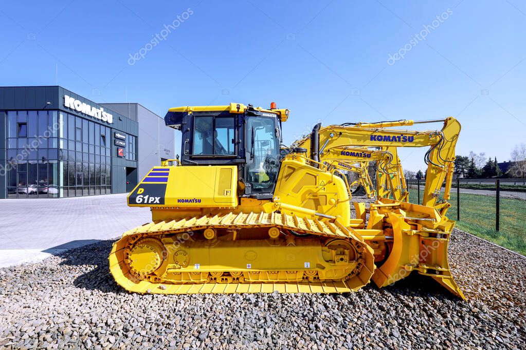 Poznan, Poland - March 28, 2025: Komatsu construction heavy equipment in front of a dealership.