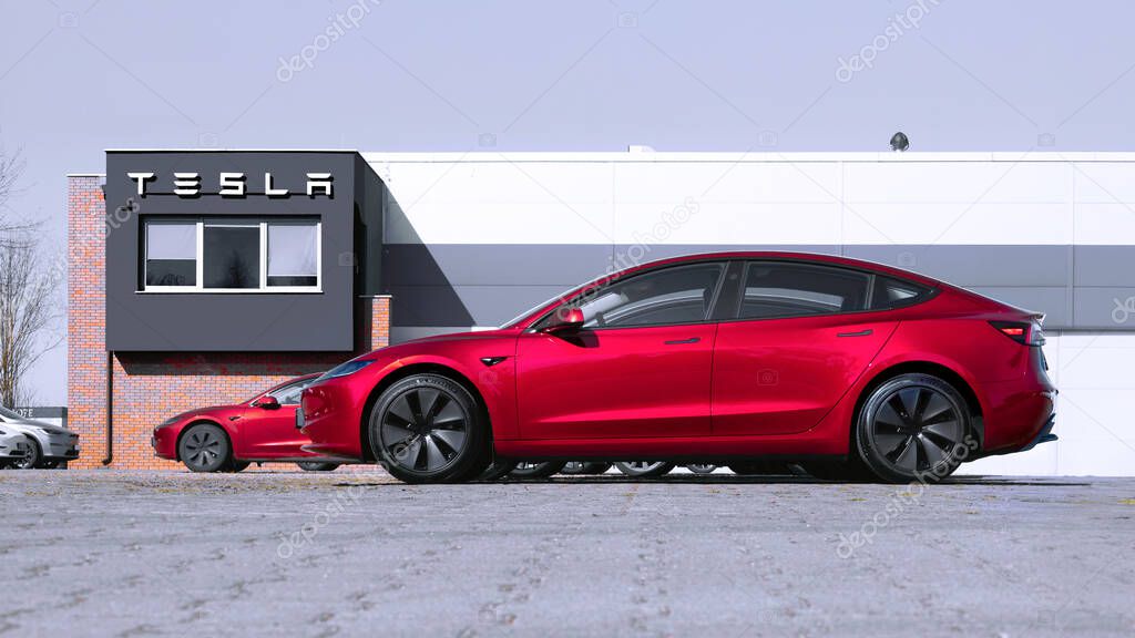 Poznan, Poland - March 28, 2025: Brand new Tesla Model 3 in front of a dealership.