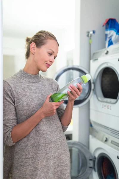 Pretty Young Woman Doing Laundry Home Choosing Carefully Washing Product — Stock Photo, Image