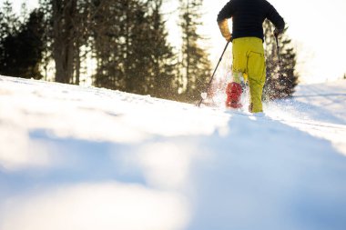 Snowshoeing in winter in deep snow. Walking in the snow. Hiking in the mountains in winter. clipart