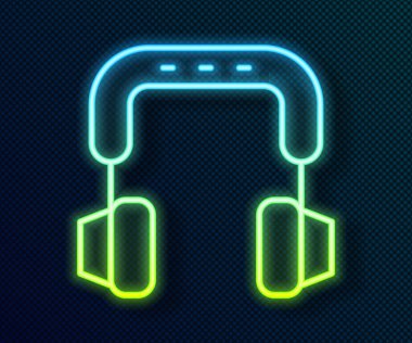 Parlayan neon hattı kulaklık simgesi siyah arkaplanda izole edildi. Kulaklıklar. Müzik, hizmet, iletişim ve operatör konsepti. Vektör