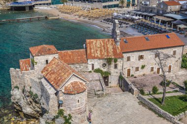 Budva, Montenegro - May 24, 2017: Saint Sava and Santa Maria in Punta on Old Town, historic part of Budva town clipart
