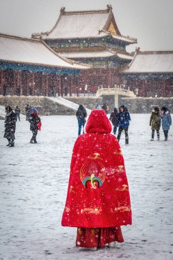 Beijing, China - February 12, 2019: Woman in a traditional coat in Forbidden City, Beijing city clipart