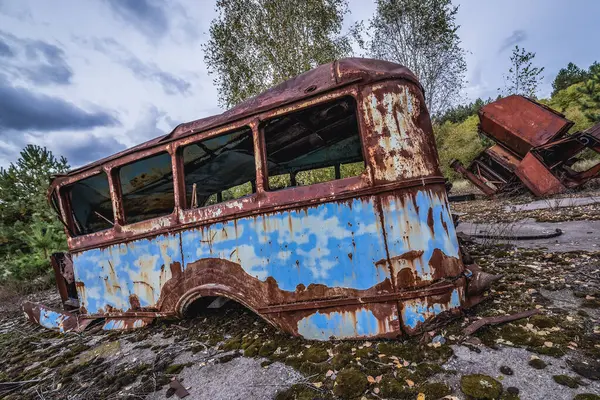 Old bus on a wrecking yard near Illinci village in Chernobyl Exclusion Zone in Ukraine