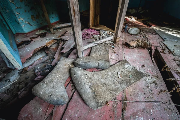 Old boots in abandoned Stechanka village in Chernobyl Exclusion Zone, Ukraine